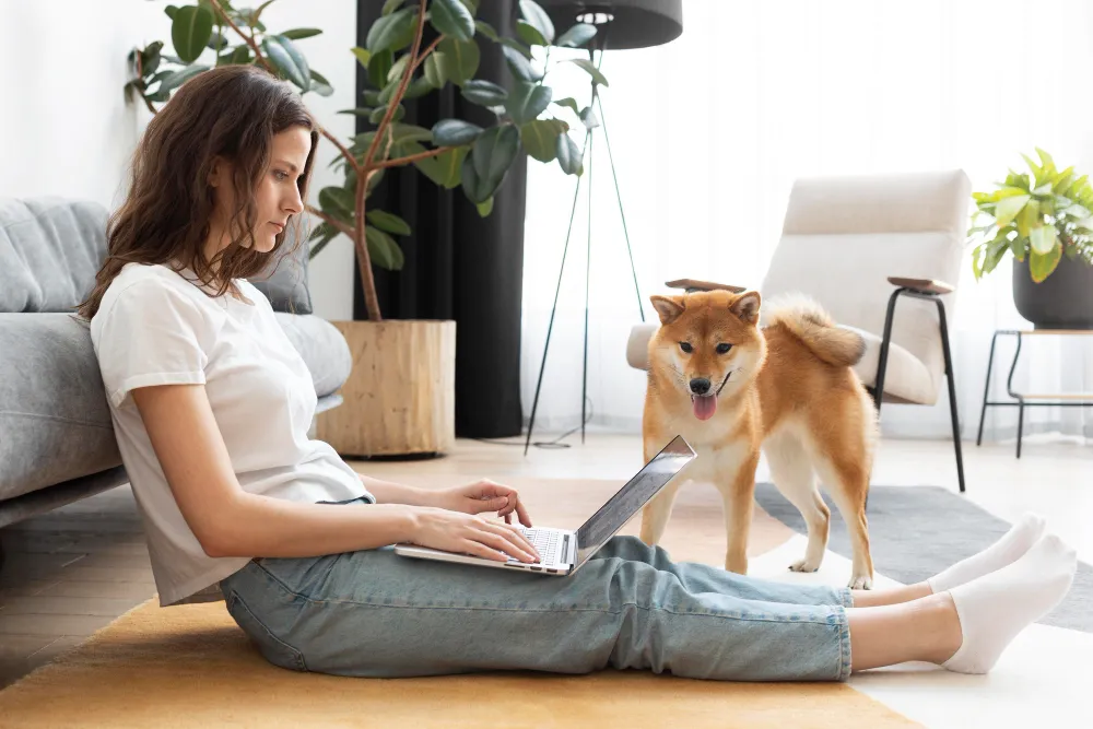 Woman completing an online ESA letter evaluation at home with her dog nearby